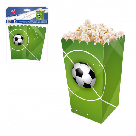 Boîte de pop-corn avec ballon de football sur l'herbe