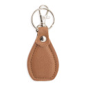 Porte-clés marron dans une boîte avec autocollant personnalisé pour les détails de la communion d'une fille