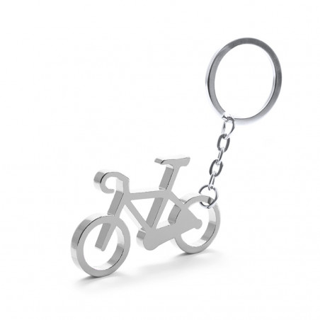 Porte-clé en forme de vélo en argent dans une enveloppe kraft avec un autocollant personnalisé pour la communion d'un garçon