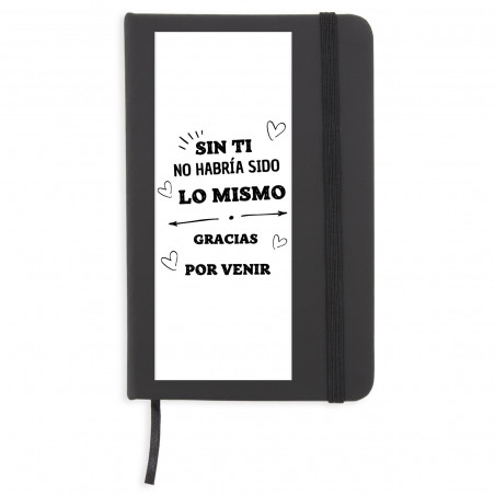Cahier noir avec des feuilles blanches avec un autocollant de gratitude