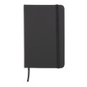 Cahier noir avec des feuilles blanches avec un autocollant de gratitude