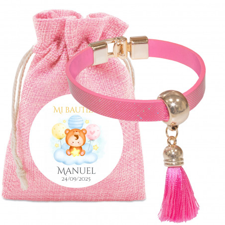 Bracelet à pompon rose dans un sac en tissu avec autocollant personnalisé pour les baptêmes