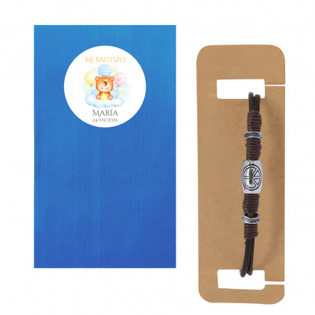 Bracelet en cuir avec le symbole de la paix présenté avec une enveloppe pour baptême
