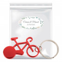 Porte-clés en forme de vélo présenté dans un sac avec rabat adhésif et autocollant herbal personnalisable