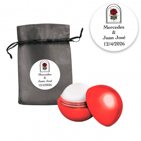 Balm à lèvres en sphère rouge présenté dans un sac en organza noir avec un autocollant personnalisable rose vintage