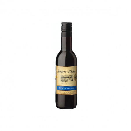 Vin rouge avec étiquette personnalisée de Noël et bracelet en acier présenté dans une boîte pour les détails.