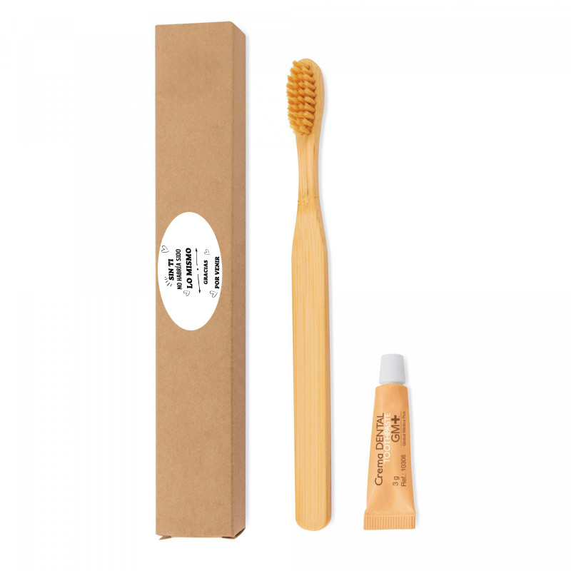 Brosse à dents en bambou et pâte dentifrice dans une boîte avec un autocollant pour les détails des événements et des fêtes.