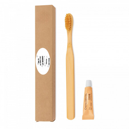 Brosse à dents en bambou et pâte dentifrice dans une boîte avec un autocollant pour les détails des événements et des fêtes.