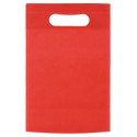 Suspension de Noël avec photo en forme de flocon de neige présentée dans un sac cadeau rouge et autocollant personnalisé